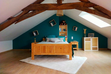 Idées déco pour une chambre mansardée ou avec mezzanine blanche et bois contemporaine de taille moyenne avec un mur vert, parquet clair et poutres apparentes.