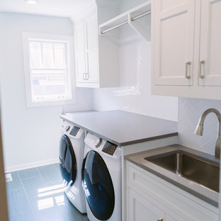 Medium sized classic galley separated utility room in Cincinnati with a single-bowl sink, white cabinets, engineered stone countertops, white walls, ceramic flooring, an integrated washer and dryer, grey floors, recessed-panel cabinets and grey worktops.