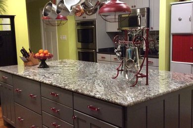 Mid-sized eclectic u-shaped eat-in kitchen photo in Other with shaker cabinets, gray cabinets, granite countertops, stainless steel appliances and an island