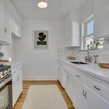 Galley Style White ADU Kitchen with Tile Backsplash