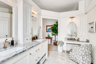 Photo of a transitional master bathroom in Denver with furniture-like cabinets, a freestanding tub, white tile, porcelain tile, limestone floors, an undermount sink, grey floor, a hinged shower door and blue benchtops.