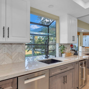 Elegant Kitchen Design with Two-Tone Cabinets and Picture Window