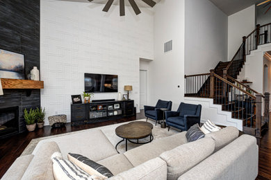 Mid-sized trendy formal and enclosed brown floor and dark wood floor living room photo in Indianapolis with a tile fireplace, a wall-mounted tv, white walls and a corner fireplace