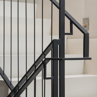Large and mixed contemporary u-shaped staircase in San Francisco with limestone treads and limestone risers.