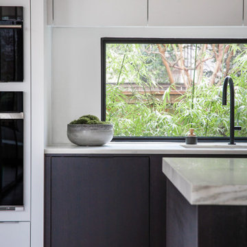 Modern Kitchen with Mitered Stone Island, Streamlined Cabinetry & Furnished Seat