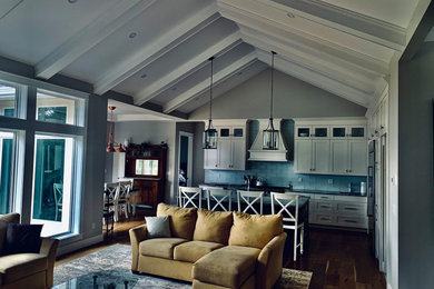 Inspiration for a modern medium tone wood floor and multicolored floor kitchen remodel in Other with a drop-in sink, white cabinets, marble countertops, blue backsplash, subway tile backsplash, stainless steel appliances and an island