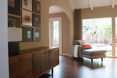 Large mid-century modern enclosed dark wood floor living room photo in San Francisco with beige walls, a standard fireplace and a brick fireplace