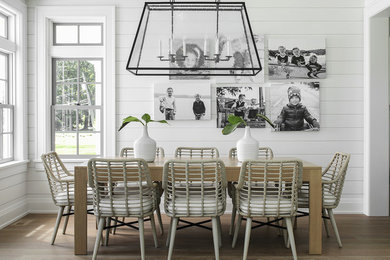Farmhouse medium tone wood floor and brown floor dining room photo in New York with white walls