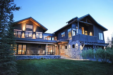 Large rustic two-story mixed siding exterior home idea in Other