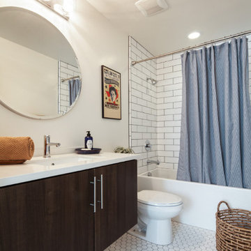 Modern Bathroom with White Subway Tile and Round Mirror