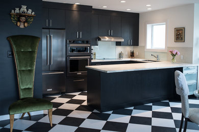 Small trendy u-shaped vinyl floor eat-in kitchen photo in Vancouver with an undermount sink, flat-panel cabinets, black cabinets, glass tile backsplash, black appliances and a peninsula
