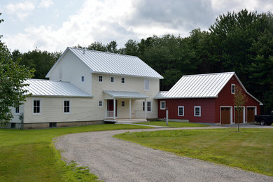 Inspiration for a mid-sized country yellow two-story vinyl exterior home remodel in Portland Maine