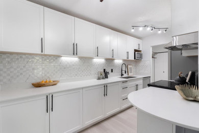 Inspiration for a large contemporary eat-in kitchen remodel in Vancouver with shaker cabinets, white cabinets, quartz countertops, white backsplash, ceramic backsplash, an island and white countertops