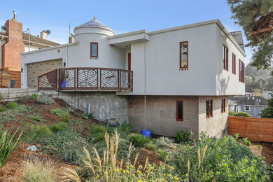 Example of a mid-sized trendy white two-story stucco exterior home design in San Francisco