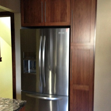 Omega Cabinetry. Plainfield door, Cherry wood, Nutmeg stain