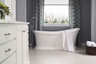 Inspiration for a timeless vinyl floor and white floor freestanding bathtub remodel in Atlanta with shaker cabinets, white cabinets, gray walls and marble countertops