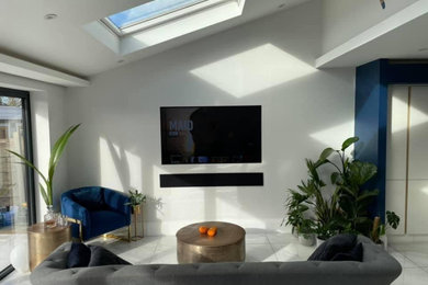 Photo of a large contemporary living room in Glasgow with white walls, ceramic flooring, a wall mounted tv and feature lighting.