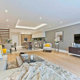 This is an example of a contemporary basement in Surrey with beige floors.