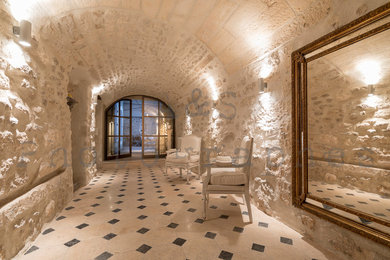 Cette photo montre un grand hall d'entrée chic avec un mur beige et tomettes au sol.
