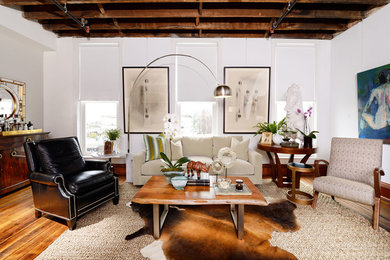 Example of a mid-sized urban enclosed medium tone wood floor living room design in St Louis with a bar, white walls, no tv and no fireplace