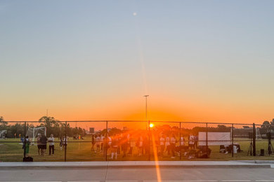 Design ideas for a huge modern full sun hillside concrete paver and metal fence landscaping in Dallas for spring.
