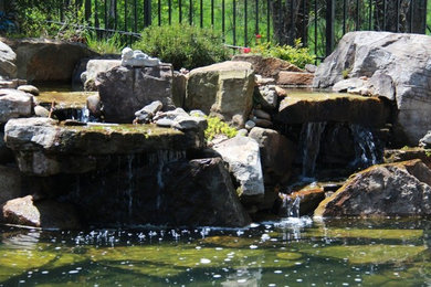 Inspiration for a mid-sized partial sun backyard stone water fountain landscape in Nashville.