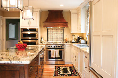 Inspiration for a mid-sized timeless l-shaped light wood floor open concept kitchen remodel in Boston with an undermount sink, recessed-panel cabinets, white cabinets, granite countertops, multicolored backsplash, porcelain backsplash, stainless steel appliances and an island