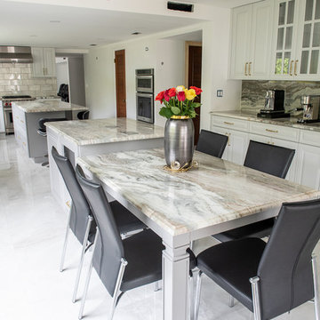 Transitional Kitchen Done in a 2 Tone Color With Integrated Dining Table