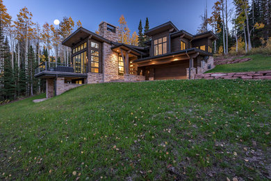 Example of a large trendy beige two-story mixed siding flat roof design in Salt Lake City