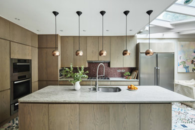 This is an example of a medium sized contemporary grey and purple l-shaped kitchen/diner in London with a double-bowl sink, flat-panel cabinets, dark wood cabinets, terrazzo worktops, multi-coloured splashback, mosaic tiled splashback, coloured appliances, an island, green floors, grey worktops, a timber clad ceiling and a feature wall.