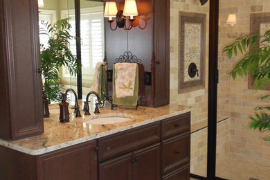 Large traditional master bathroom in Other with recessed-panel cabinets, dark wood cabinets, an alcove shower, beige tile, subway tile, beige walls, porcelain floors, an undermount sink, granite benchtops and a drop-in tub.