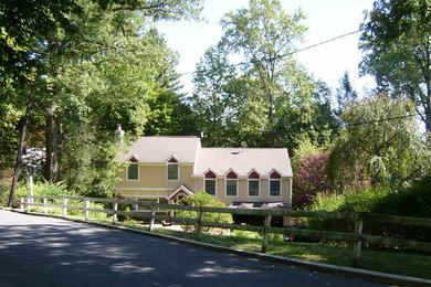 Large traditional beige two-story vinyl exterior home idea in New York with a shingle roof