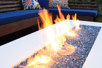 Design ideas for a mid-sized contemporary backyard patio in Other with a fire feature, decking and no cover.