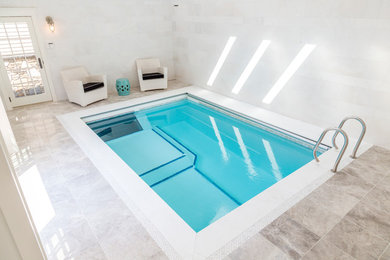 Example of a beach style backyard rectangular lap pool design in Boston