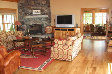 Inspiration for a large timeless enclosed light wood floor living room remodel in Boston with beige walls, a standard fireplace, a stone fireplace and a tv stand