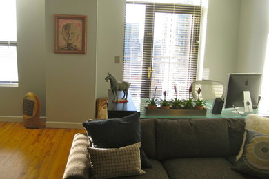 Inspiration for a mid-sized contemporary loft-style medium tone wood floor living room remodel in Chicago with gray walls, a standard fireplace, a tile fireplace and a tv stand