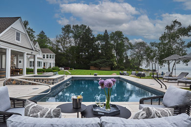 Hot tub - large transitional backyard concrete paver and rectangular lap hot tub idea in Milwaukee