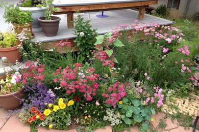 Photo of a mid-sized traditional full sun backyard concrete paver landscaping in Denver for summer.