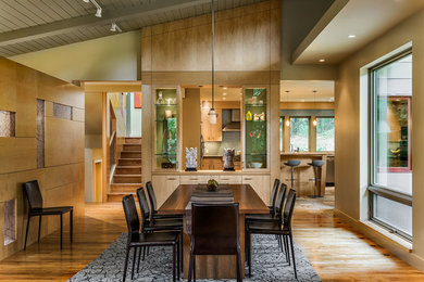 Example of a trendy medium tone wood floor dining room design in Burlington with beige walls