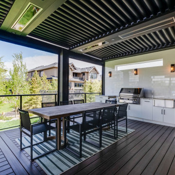 Adjustable StruXure Pergola Featuring Outdoor Kitchen With Screens & Heaters