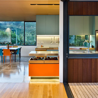 Large contemporary kitchen pantry remodeling - Example of a large trendy single-wall kitchen pantry design in Wellington with stainless steel countertops and an island