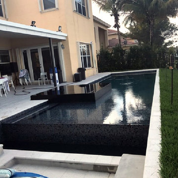 Contemporary pool with two tone recycled glass mosaic mixes