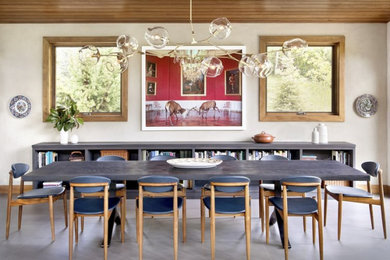 Inspiration for a medium sized bohemian enclosed dining room in Denver with red walls, marble flooring and no fireplace.
