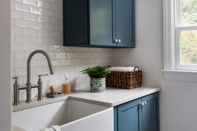 Example of a beach style laundry room design in Boston