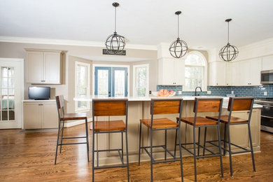 Huge transitional u-shaped dark wood floor open concept kitchen photo in Other with an undermount sink, shaker cabinets, gray cabinets, quartz countertops, blue backsplash, glass tile backsplash, stainless steel appliances and an island