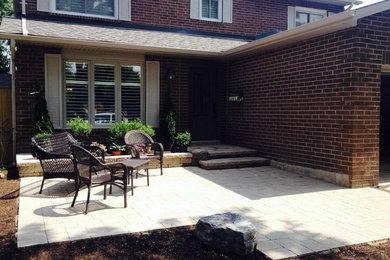 Patio - traditional front yard brick patio idea in Toronto with no cover