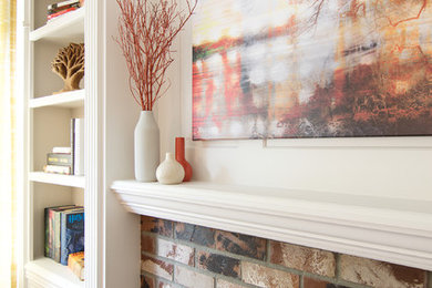 Enclosed dining room - mid-sized transitional laminate floor and brown floor enclosed dining room idea in Seattle with white walls, a standard fireplace and a brick fireplace