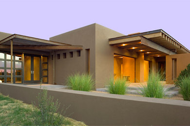 Inspiration for a large contemporary one-storey stucco brown exterior in Albuquerque.