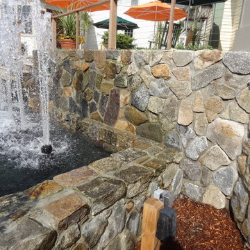 Cape Cod Inn with New England Stone Cladding, Retaining Walls, and Water Feature