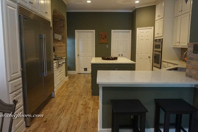 Large farmhouse u-shaped porcelain tile and beige floor kitchen photo in Houston with an undermount sink, raised-panel cabinets, white cabinets, quartz countertops, brown backsplash, brick backsplash, stainless steel appliances and an island